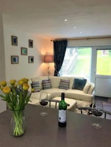 a bottle of wine on a table in a living room at Springer Villa, 2 bed, Newquay in Newquay