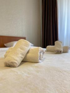 2 Handtücher auf einem Bett in einem Hotelzimmer in der Unterkunft микрорайон Астана с кодовым замком in Oral