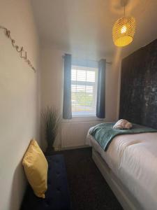 a bedroom with a bed and a window at CAPRI 13 SA's 3 bedroom home, close to Loughborough University and M1 in Loughborough