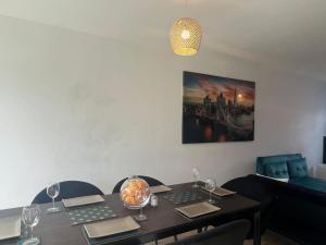 a dining room table with wine glasses and a picture on the wall at CAPRI 13 SA's 3 bedroom home, close to Loughborough University and M1 in Loughborough