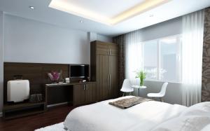 a bedroom with a bed and a tv and a window at Eco Luxury Hotel Hanoi in Hanoi