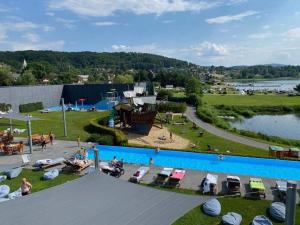 einen Blick über einen Pool mit Menschen in einem Park in der Unterkunft L57_resort in Gmina Gródek nad Dunajcem