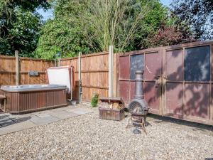 a backyard with a grill and a fence at Just The Ticket - Uk44791 in Barney