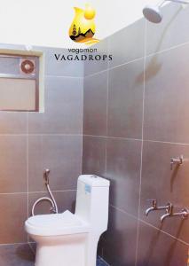 a bathroom with a toilet and a shower at VAGAMON VAGADROPS in Vagamon