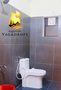 a bathroom with a toilet and a sign on the wall at VAGAMON VAGADROPS in Vagamon