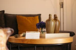 a wooden table with two vases and books on it at Viosinho guest house in Alijó