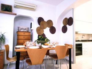 a dining room with a wooden table and chairs at EBREHOME in Deltebre
