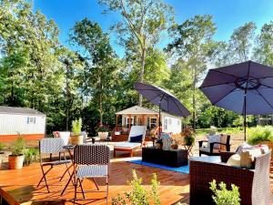 a patio with chairs and tables and umbrellas at SLEEPS SIX - Rent Entire WATERFRONT CABIN #1 