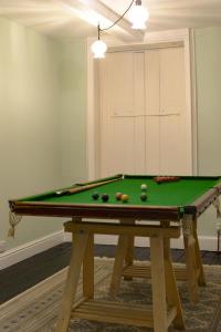 a pool table with balls on it in a room at Bressingham Hall in Bressingham
