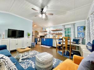 a living room with a couch and a table and a kitchen at SLEEPS SIX - Rent Entire WATERFRONT CABIN #1 in Etoile
