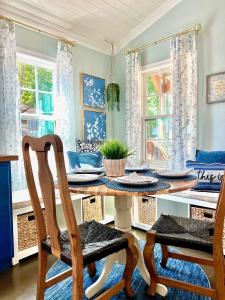 a dining room with a table and chairs and windows at SLEEPS SIX - Rent Entire WATERFRONT CABIN #1 in Etoile +34 photos