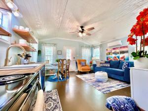 a kitchen and living room with a blue couch at SLEEPS SIX - Rent Entire WATERFRONT CABIN #1 in Etoile