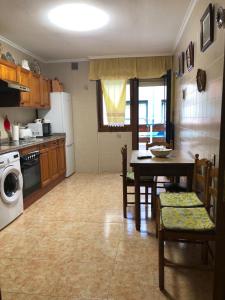 eine Küche mit einem Tisch und Stühlen sowie ein Esszimmer in der Unterkunft Apartamento Casa Belén Arriondas in Les Arriondes
