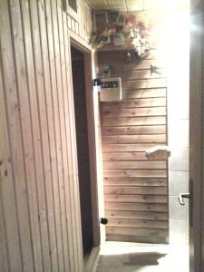une porte menant à une chambre dotée d'un mur en bois. dans l'établissement Penzion Adam - Makov, à Makov