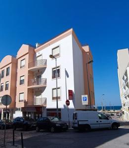a white van parked in front of a building at Casa de Praia da Zezinha in Costa da Caparica