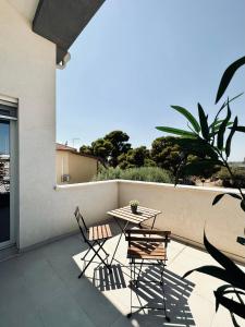 a table and two chairs on a patio at Villa Noga Rooms in Selargius