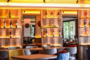 a restaurant with tables and chairs and lights on the wall at Mon réve Nlux79 in Kopaonik