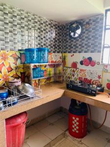 a kitchen with a counter with pots and pans at Raga Homestay 2.0- Urban Comfort in Guwahati
