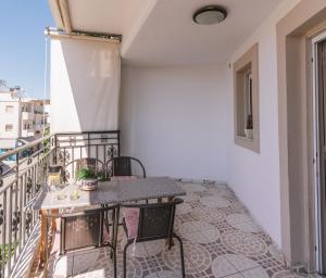 a balcony with a table and chairs on it at Katerina Family Apartments in Moírai