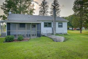 a small white house with a pole in the yard at Quaint Horseheads Home with Screened-In Patio! in Horseheads