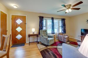 a living room with a ceiling fan and a table and chairs at Quaint Horseheads Home with Screened-In Patio! in Horseheads