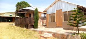 a house with a tree in front of it at Marima Safari in Sekenani