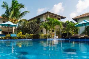 a swimming pool in front of a villa at Ananthaya Beach in Tangalle