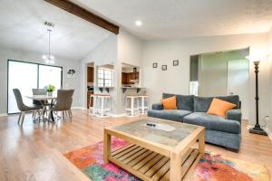 a living room with a couch and a table at Fairburn Home with 2 Decks, Grill and Outdoor Dining! in Fairburn