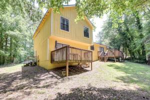 a yellow house with two decks on the side of it at Fairburn Home with 2 Decks, Grill and Outdoor Dining! in Fairburn