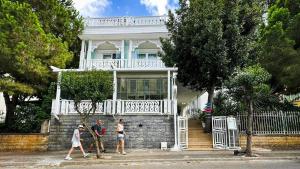 a group of people walking in front of a house at hi HOTEL IVY BÜYÜKADA in Adalar
