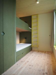 a room with a bunk bed and a wooden floor at Bleibe Menzenschwand in St. Blasien