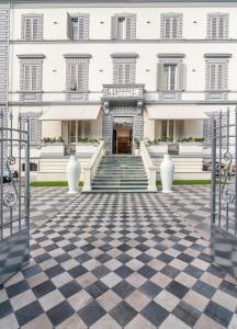 a large white building with a checkered floor at Hotel Tirreno in Marina di Massa
