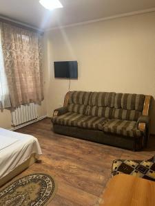 sala de estar con sofá y TV en Hotel KA-EL en Musalerr
