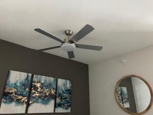 a ceiling fan and a mirror in a room at Luxury Oceanview Studio at Miami Design District in Miami