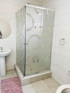 a shower with a glass door in a bathroom at Stunning Modern Home in Maseru in Maseru