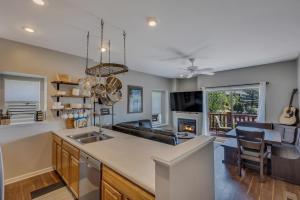 a kitchen with a sink and a living room at 1032 Luxury Eaglepointe Townhome in Steamboat Springs