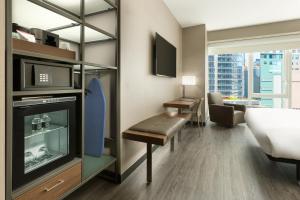 a hotel room with a bed and a television at AC Hotel by Marriott New York Times Square in New York