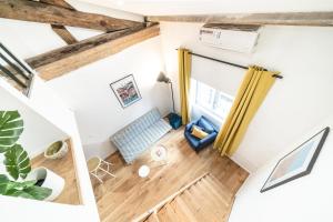 an overhead view of a living room with wood floors at Cocon élégant 3 pers -Perrache-Confluence in Lyon