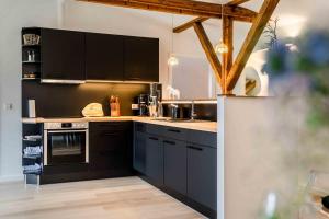 a kitchen with black cabinets and a counter top at Studio Zwei in Oersberg