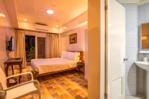 Rúm í herbergi á Bernardo's Lantia Hotel