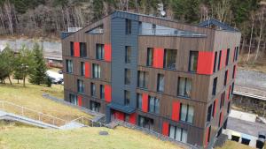 an aerial view of a building with red windows at Apartmá v klidné lokalitě Krkonoš. in Pec pod Sněžkou