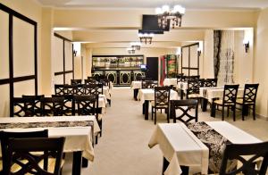 a dining room with tables and chairs and a restaurant at Stupari in Shaian