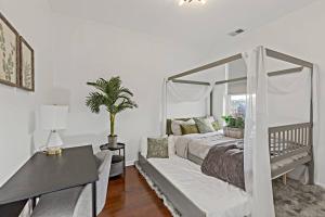 ein Schlafzimmer mit einem Himmelbett und einem Tisch in der Unterkunft The Penthouse, Lux stay near Downtown, UofC & Lake in Chicago