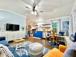 a living room with a blue couch and a kitchen at SLEEPS SIX - Rent Entire WATERFRONT Cabin #2 in Etoile
