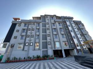 a large white building with a lot of windows at HOTEL ROYAL VANILLA in Siliguri