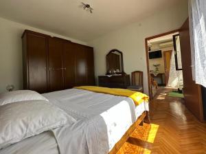 a bedroom with a bed and a dresser and a mirror at Apartments Bilić in Vis