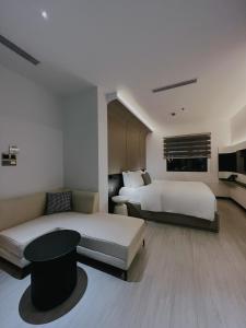 ホーチミン・シティにあるThe Concept Hotel HCMC- District 1のベッド2台とテレビが備わるホテルルームです。