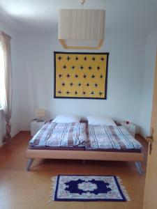 a bedroom with a bed with a picture on the wall at Ferienwohnung Zuschke in Klipphausen