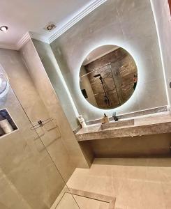 a bathroom with a sink and a mirror at Villa avec piscine privée sur agadir in Agadir