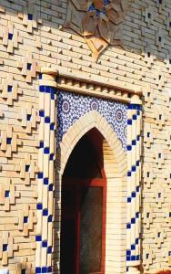 a building with an arch with a blue and white at Colibri Traditional Hostel in Samarkand